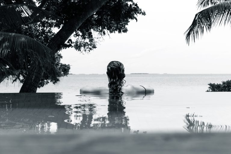 Young adult woman relaxing in a swimming pool